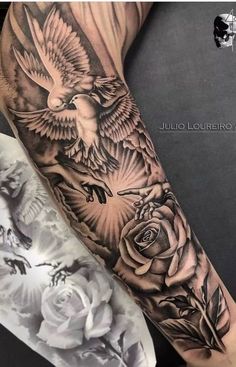 a black and white photo of a bird with roses on it's arm by julia lourrio