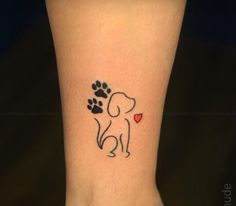 a small dog paw with a heart tattoo on the ankle and foot is shown in black ink