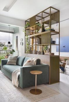 a living room filled with furniture and plants