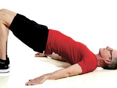 a man in red shirt and black shorts doing push ups on white floor with one leg up