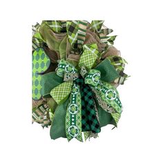 a green and white wreath with bows