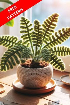 a crocheted potted plant sitting on top of a wooden table next to a window