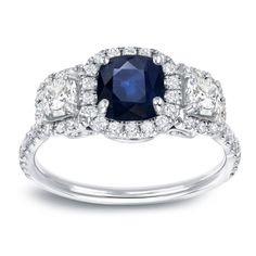 a blue and white diamond ring with three stone accents