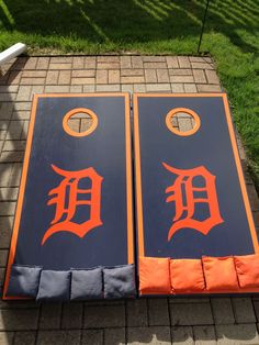 two blue and orange cornhole boards with the detroit tigers on them