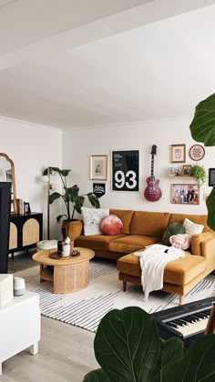 a living room filled with furniture and plants