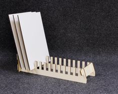 a stack of white cards sitting on top of a wooden rack next to each other