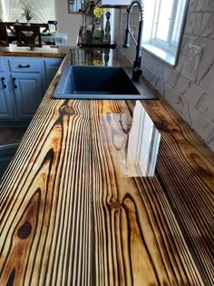 a wooden counter top in a kitchen next to a sink