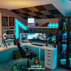 a room with a desk, chair and computer monitor on the wall is lit up by neon lights