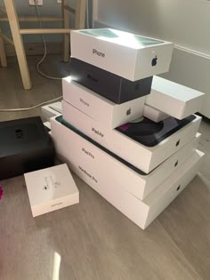 several boxes stacked on top of each other with an iphone in the middle one box