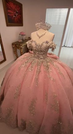 a dress on display in a room with a mannequin wearing a tiara