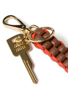 a keychain with an orange and brown braid on it