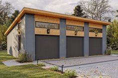 a two car garage with three windows on the front and one door open to let in lots of light