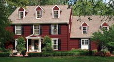 a red house with white trim and black shutters