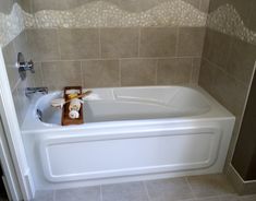 a white bath tub sitting inside of a bathroom