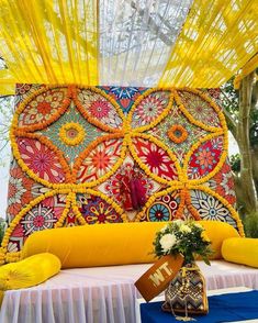 an elaborately decorated bed with bright yellow drapes