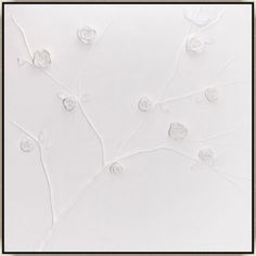 a white wall with flowers and leaves on it