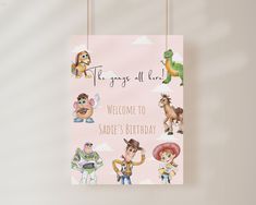 a pink birthday card with toy story characters hanging from it's sides and the words, toys all here welcome to sadie's birthday