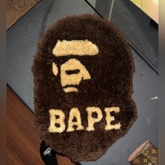 a brown rug with the word bape written on it