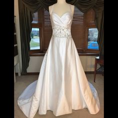 a wedding dress on display in front of a window