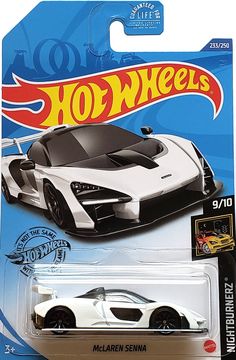 a white and black toy car with flames on it's back end, in a package