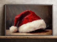 a painting of a santa hat on a shelf