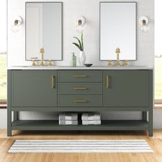 a bathroom with two sinks, mirrors and rugs on the wooden floor next to it