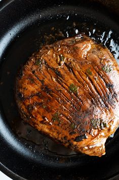 a close up of a steak in a skillet