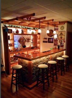 an image of a bar with stools in the middle and lights on above it