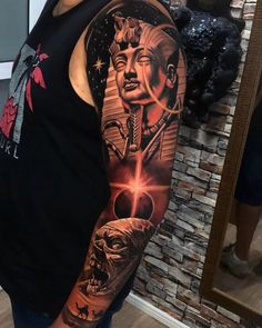 a man's arm with an image of buddha and other things on the side