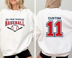 Custom Baseball Sweatshirt, Personalized Baseball Shirt, Baseball Team Name Sweater, Baseball Crewneck, Game Day Hoodie, Baseball Mom Shirt DESCRIPTION: Elevate your fashion game with our exclusive products. This eye-catching piece seamlessly blends unique design with modern comfort, making it a must-have addition to your wardrobe. Our products offer a soft touch against your skin, providing breathability that ensures you stay comfortable throughout the day. Remember, it's not just clothing; it's an expression of your personality. Embrace the quality, embrace the style. Order now and experience the difference! If you have any questions or need assistance, please don't hesitate to contact us. We're here to help you. Why Choose Our Product? Attention to Detail: Our team takes pride in handcr Name Sweater, Baseball Sweatshirts, Baseball Mom Shirt, Personalized Baseballs, Baseball Mom Shirts, Baseball Shirt, Team Name, Baseball Mom, Baseball Team