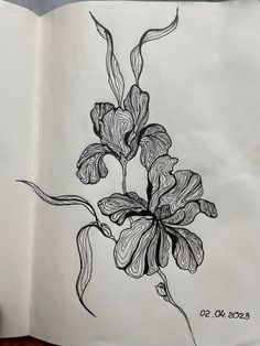 an open book with a drawing of flowers on it