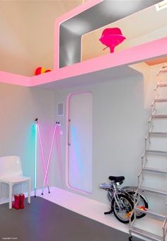 there is a bike that is parked in the room with stairs and ladders on the wall