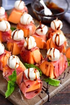 small appetizers are arranged on a cutting board