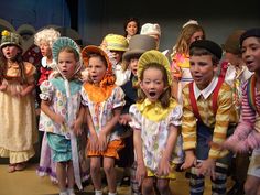 the children are dressed in costumes and singing