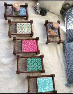 four wooden trays with different designs on them sitting on top of a white rug