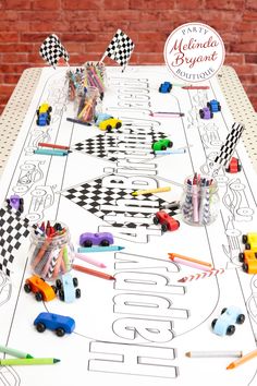 a white table topped with lots of toys on top of a checkered table cloth