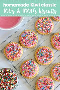 sprinkle covered cookies on a cooling rack next to a bowl of pink icing