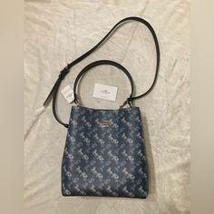 Authentic Blue Printed Coated Canvas And Smooth Leather Bucket Bag. It Has A Center Zip Compartment, Snap Closure, And Silver Hardware. Approximate Measurements Are: 10 1/4" (L) X 10" (H) X 5" (W) Handle With 8" Drop Detachable Strap With 20 1/2" Drop For Shoulder Or Crossbody Wear. No Trades Or Low Ball Offers. Designer Blue Rectangular Bucket Bag, Blue Rectangular Bucket Bag With Detachable Handle, Blue Satchel Bucket Bag With Dust Bag, Blue Formal Bucket Bag, Formal Blue Bucket Bag, Blue Bucket Bag With Detachable Strap, Blue Top Handle Bucket Bag With Detachable Strap, Blue Bucket Bag With Detachable Strap And Top Handle, Designer Blue Coach Shoulder Bag