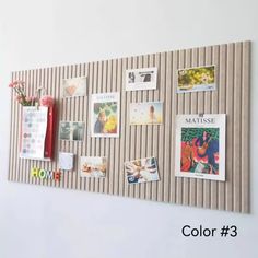 a bulletin board with pictures and magnets attached to the wall, along with flowers