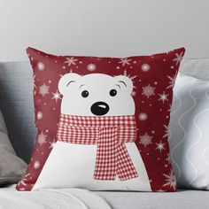 a white polar bear wearing a red and white checkered scarf with snowflakes on it