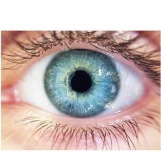 an eye with blue and green colored iris