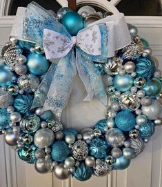 a wreath with blue and silver ornaments on it