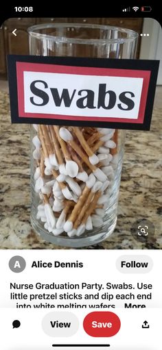 a glass jar filled with marshmallows sitting on top of a counter