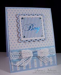 a blue and white card with a bow on it