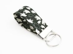 a black and white cat print belt with metal buckles on the front, featuring cats all over it