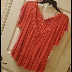 *The Perfect Mix Of A Red/Orange Color. *Light And Flowy. *Beautiful Accents. *Buttons Down For Show. *Lace Look Around Neck. *Very Soft To Touch Orange V-neck Top For Day Out, Flowy Orange V-neck Blouse, Red Rayon Top For The Beach, Flowy Red Short Sleeve Tops, Orange Flowy Top For Summer, Red Flowy Top For Vacation, Flowy Orange Summer Blouse, Flowy Orange Summer Top, Flowy Orange Blouse For Summer