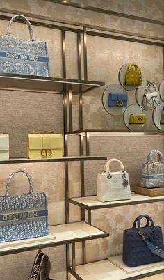 a display case filled with lots of purses and handbags on top of shelves