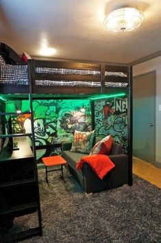 a living room with a couch and bunk bed next to a wall covered in graffiti