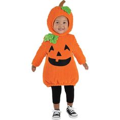 a young child wearing an orange knitted costume with a pumpkin on it's chest