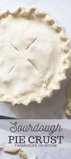 an uncooked pie crust on top of a table with a knife and spoon